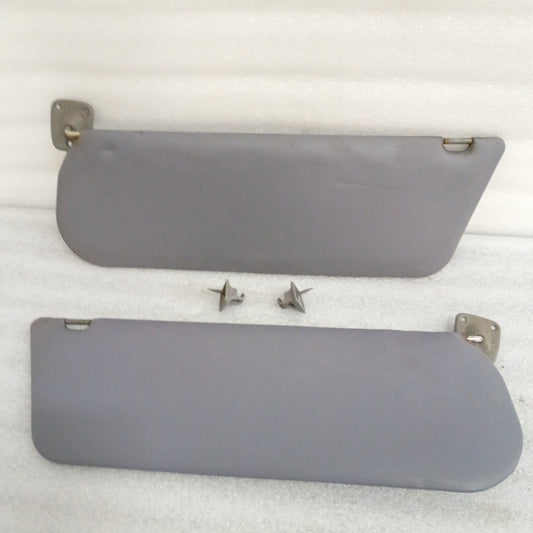Light gray vinyl sun visors with hinges and swivels for Ford F150, F250, F350, and Bronco, compatible with 1992-1997 models.