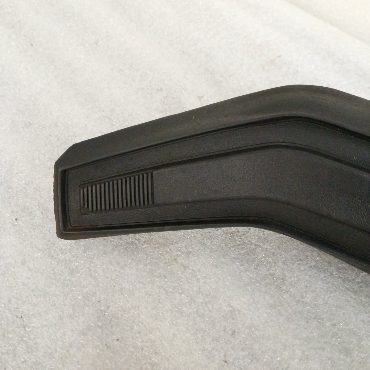 Black steering wheel horn button with vinyl grain, compatible with Ford F150, F250, F350, Bronco, showing some wear.