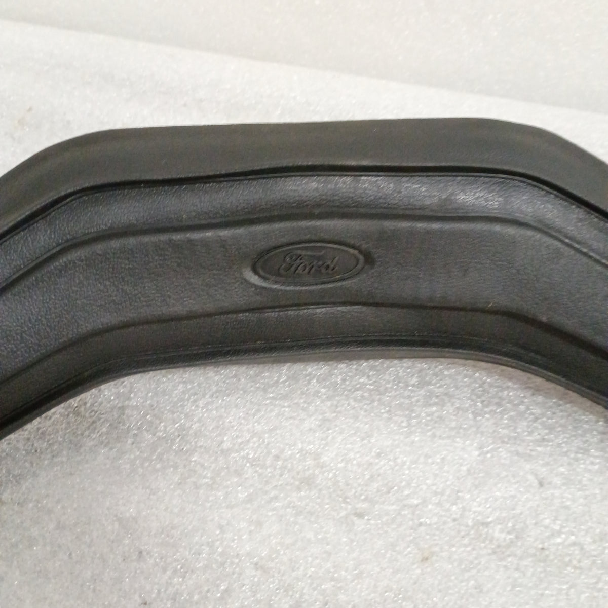 Black vinyl Ford steering wheel horn button with logo, worn corners, compatible with 80-86 F150 F250 F350 Bronco.