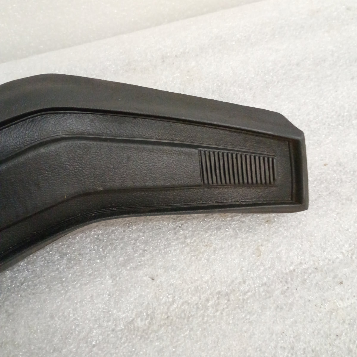 Black Ford steering wheel horn button with textured vinyl and slight corner wear, compatible with 80-86 F150, F250, F350, Bronco.