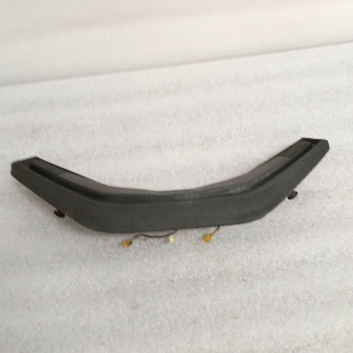 Black Ford steering wheel horn button, model 13K803, with worn corners and vinyl grain pattern, compatible with F150-F350, Bronco.