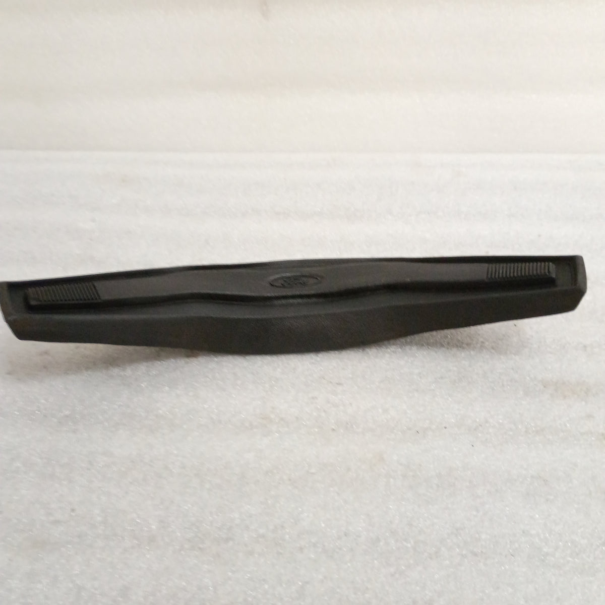 Black Ford steering wheel horn button for F150/F250/F350/Bronco, OEM, vinyl grain, Ford logo in center.