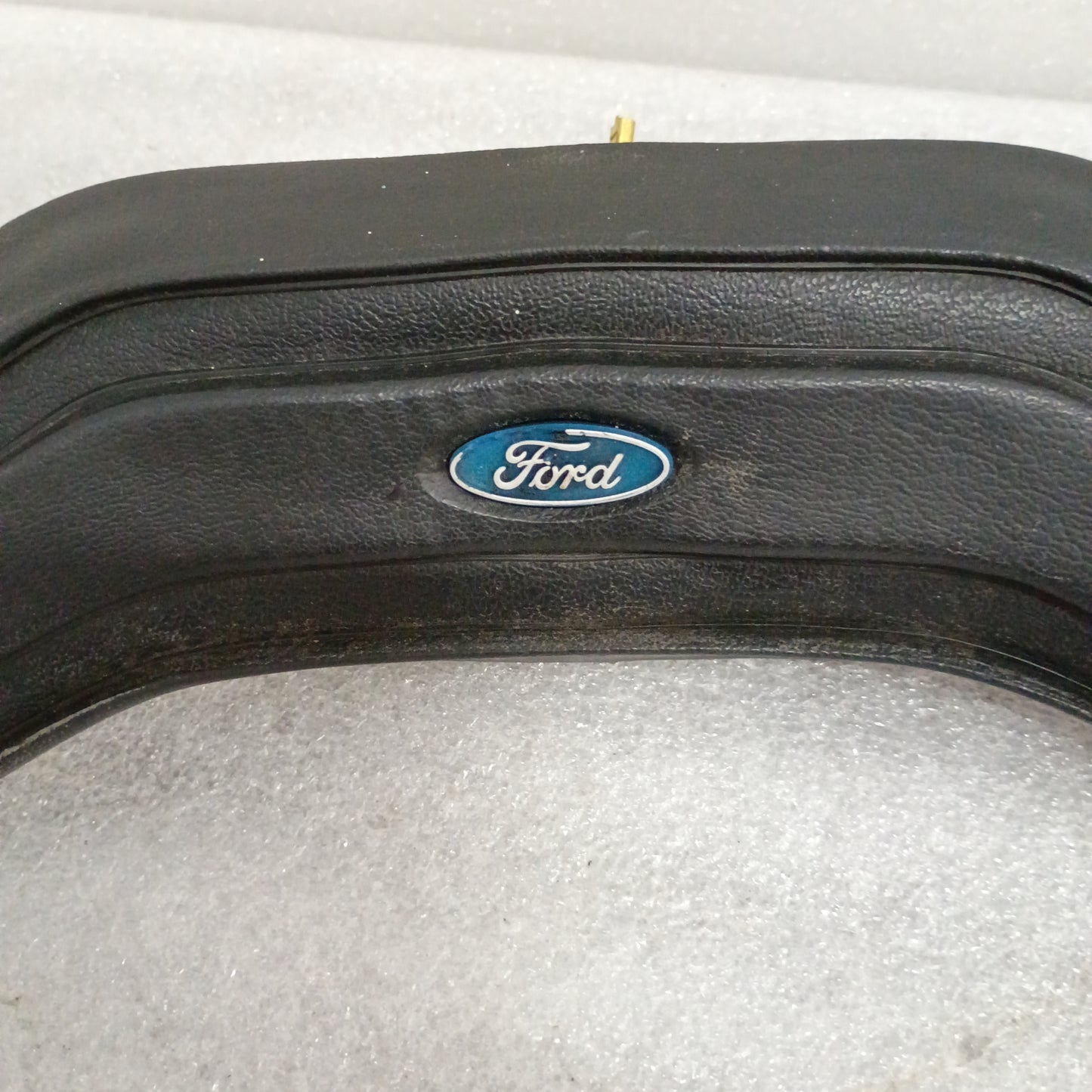 Black Ford steering wheel horn button with logo, fits 80-86 F150, F250, F350, Bronco. Vinyl grain, worn corners, part 13K803.