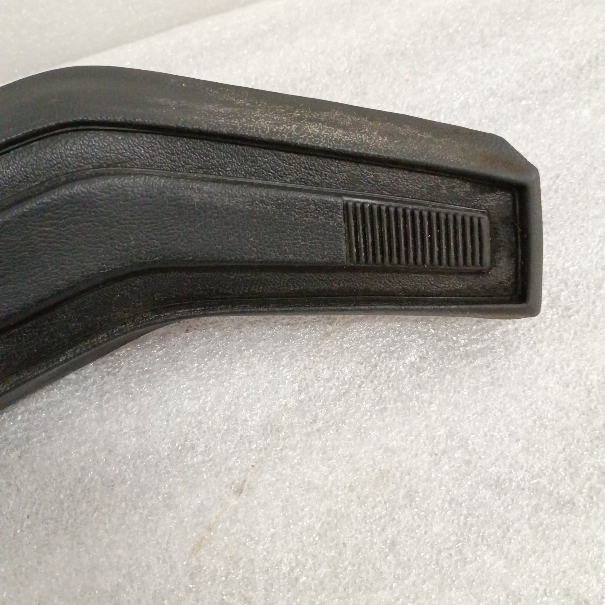 Black Ford steering wheel horn button with vinyl grain texture, slightly worn corners, compatible with F150, F250, F350, Bronco.
