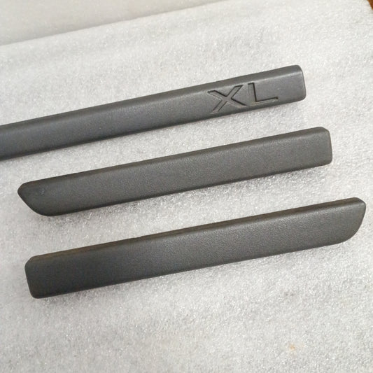 Set of three charcoal black dash trim strips for Ford F150-F350, one with "XL" marking, in excellent used condition.