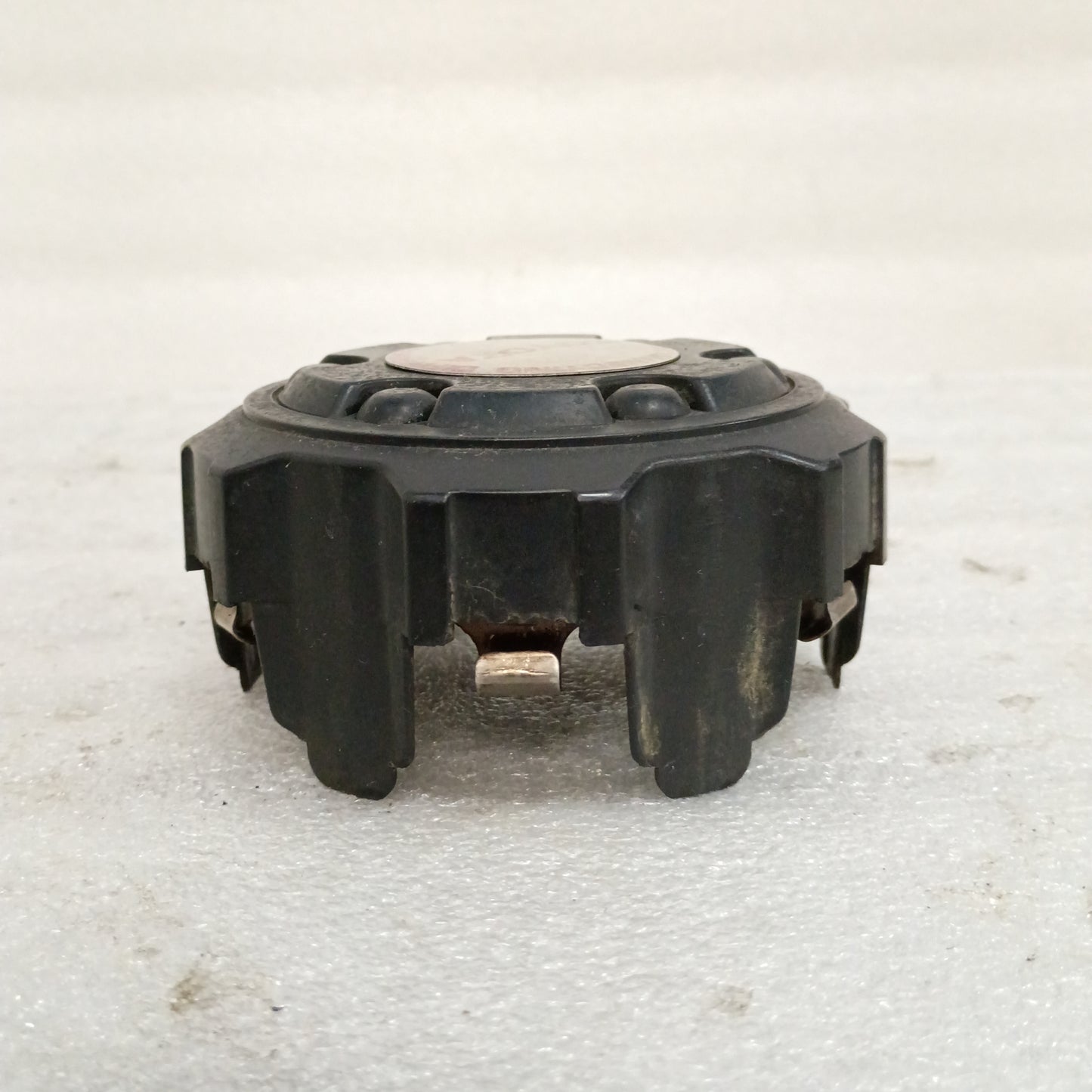 Black Toyota wheel center cap for 86-95 4Runner, Pickup, T100 models, OEM Part 69305, with minor cosmetic wear.