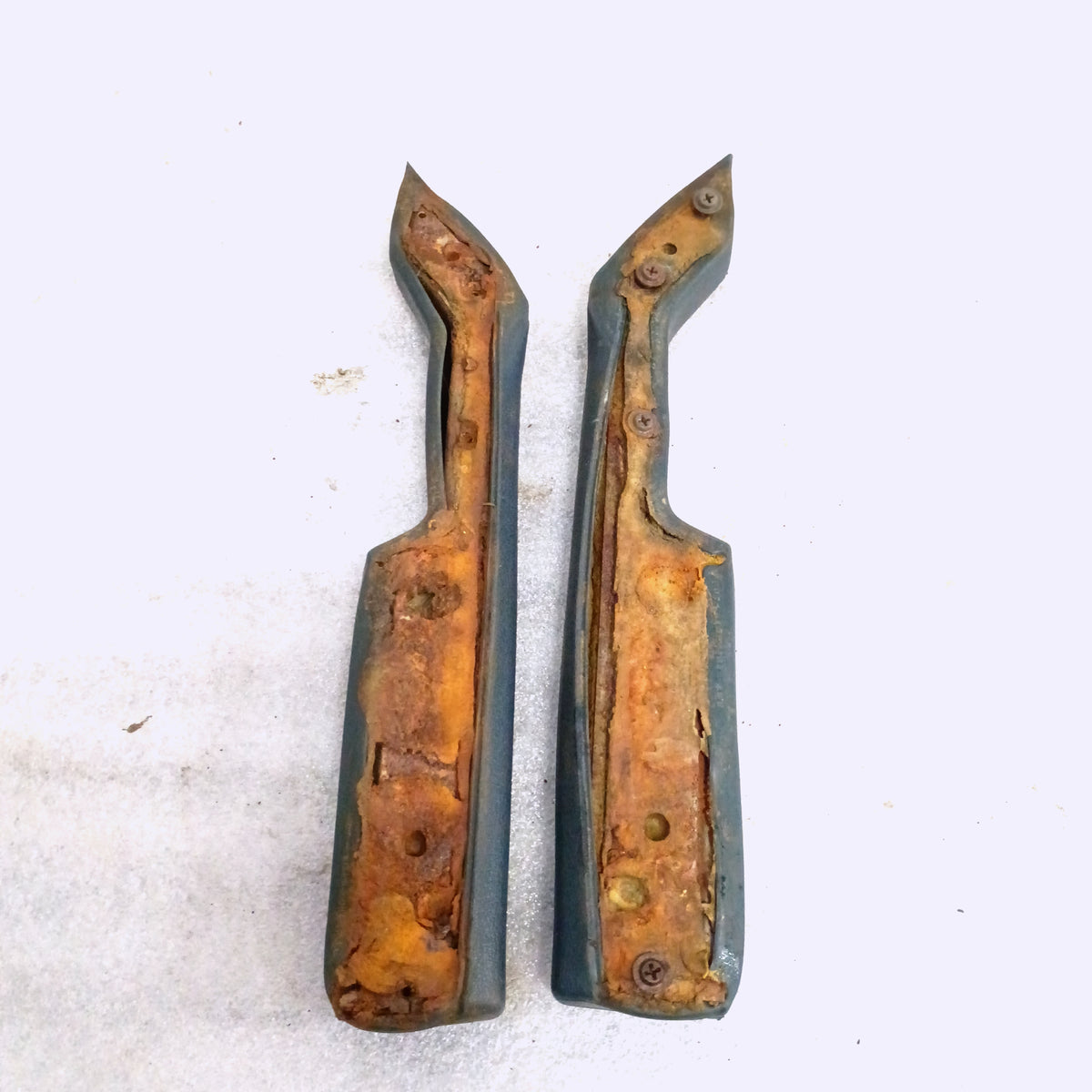 Dark Harbor Blue armrest set for Ford F150-F350, Bronco (1980-1986), shows underside and wear, OEM part E0TB-1024100-AWC.
