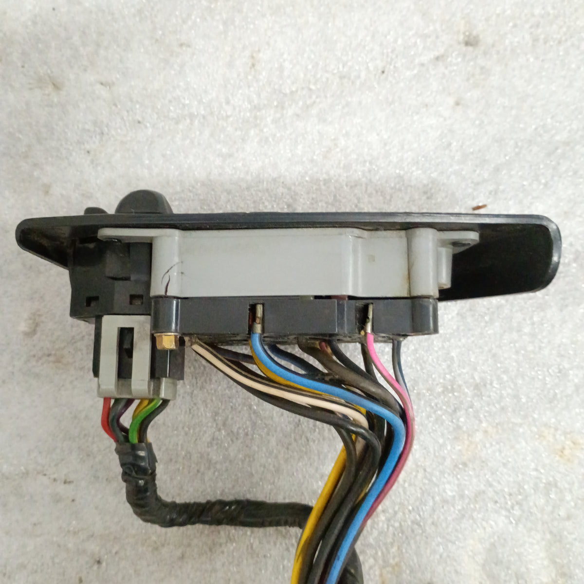 Black power window, lock, and mirror switch set with wiring for Ford vehicles, showing side view with colored wires.