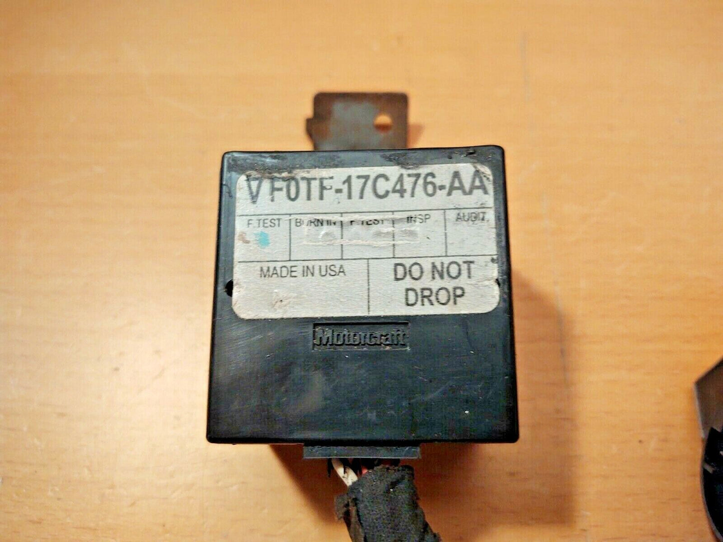 Motorcraft intermittent wiper delay module (part F0TF-17C476-AA) for 1980-1991 Ford trucks and Broncos. Black rectangular housing with an embossed Motorcraft logo and a white label marked Made in USA and Do Not Drop.