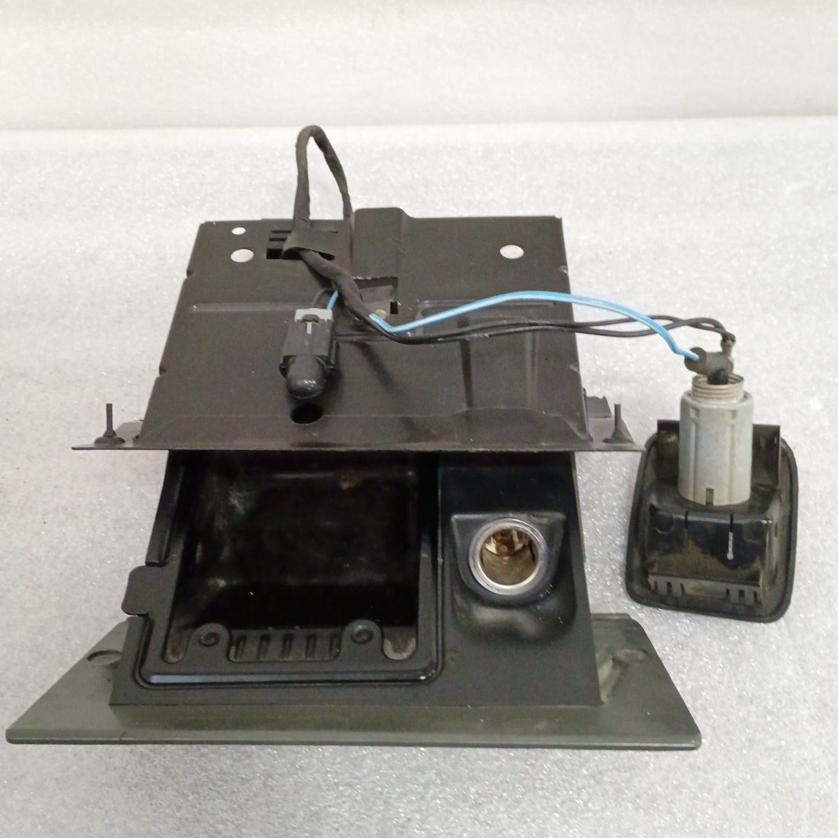 Dark granite gray ashtray assembly with mounting bracket and power port for 1992-1996 Ford F150, F250, F350, and Bronco.