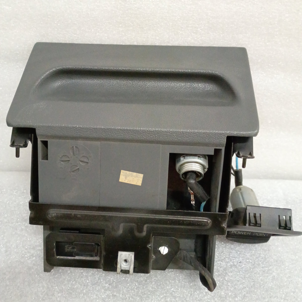 Dark gray ashtray assembly with mounting bracket and power port for 1992-1996 Ford F150, F250, F350, Bronco.