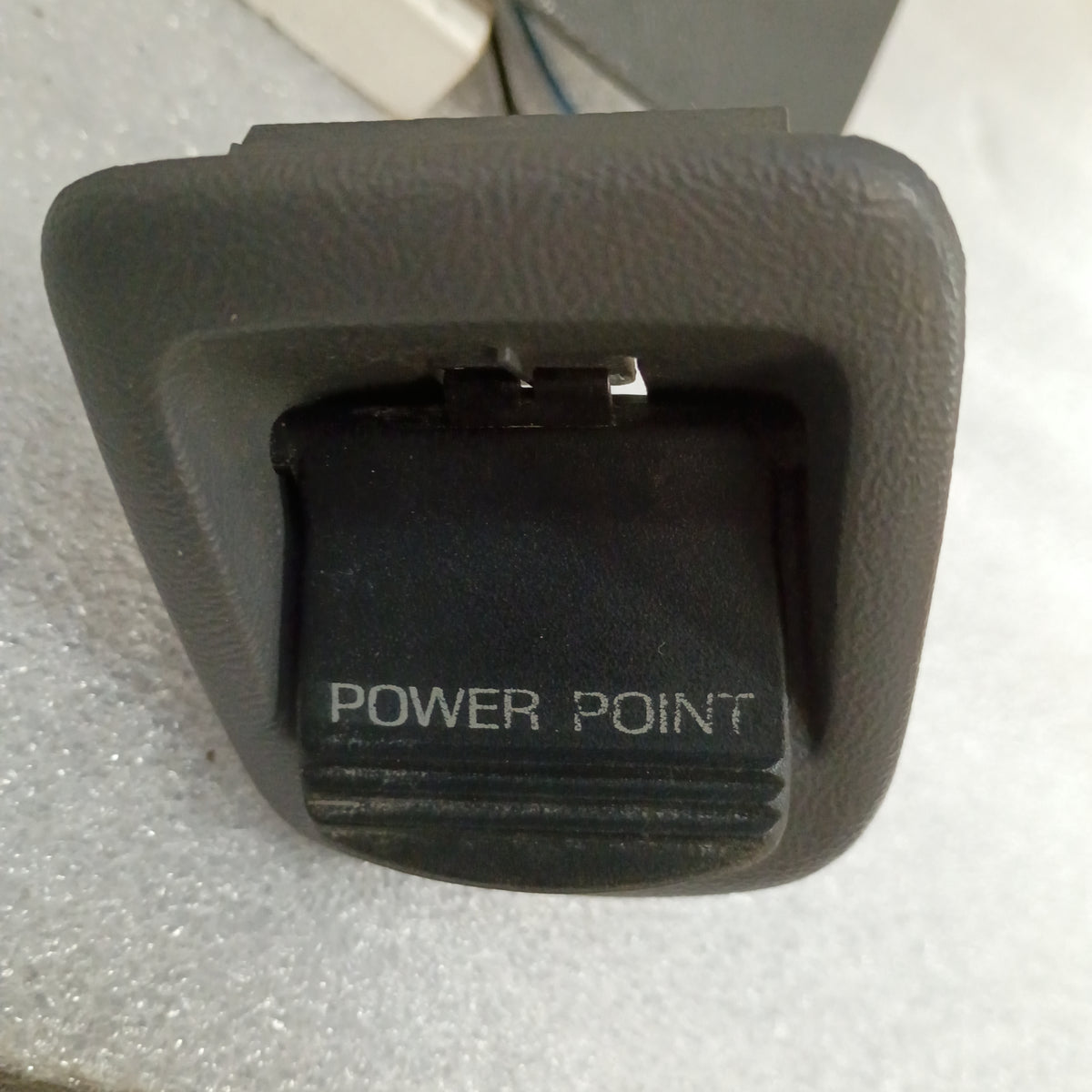Dark gray ashtray assembly for 1992-1996 Ford trucks, featuring a "Power Point" label and mounting bracket.