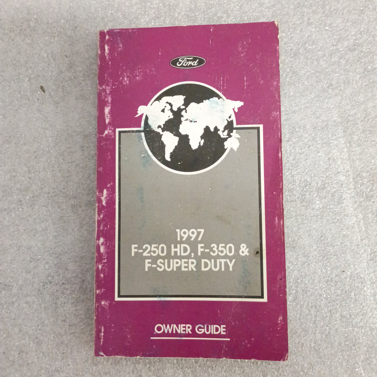 1997 Ford Owner Guide for F-250 HD, F-350, F-Super Duty with world map graphic on cover, slightly worn condition.