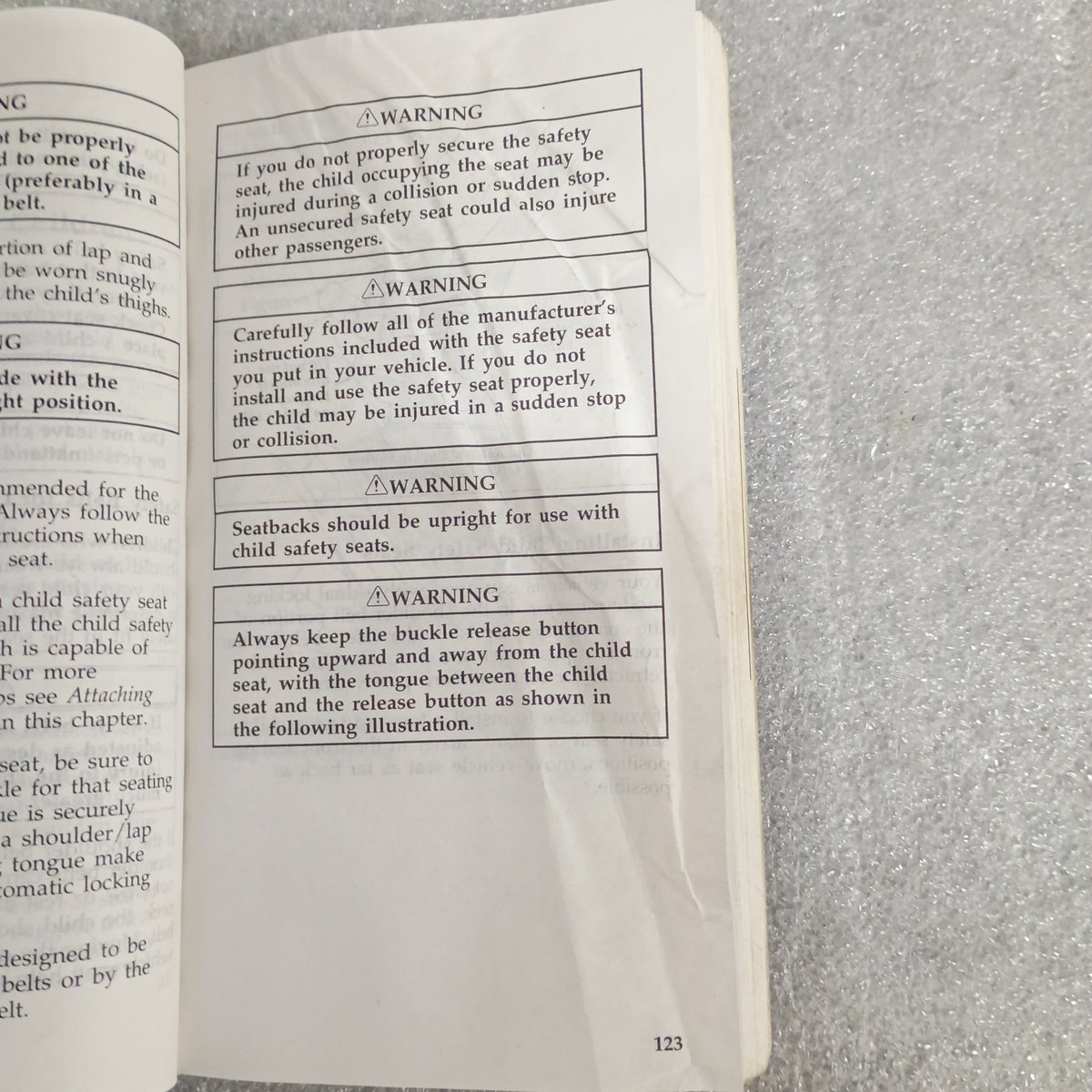 Open page of the 1997 Ford owner guide manual showing safety seat warnings and instructions, page 123.