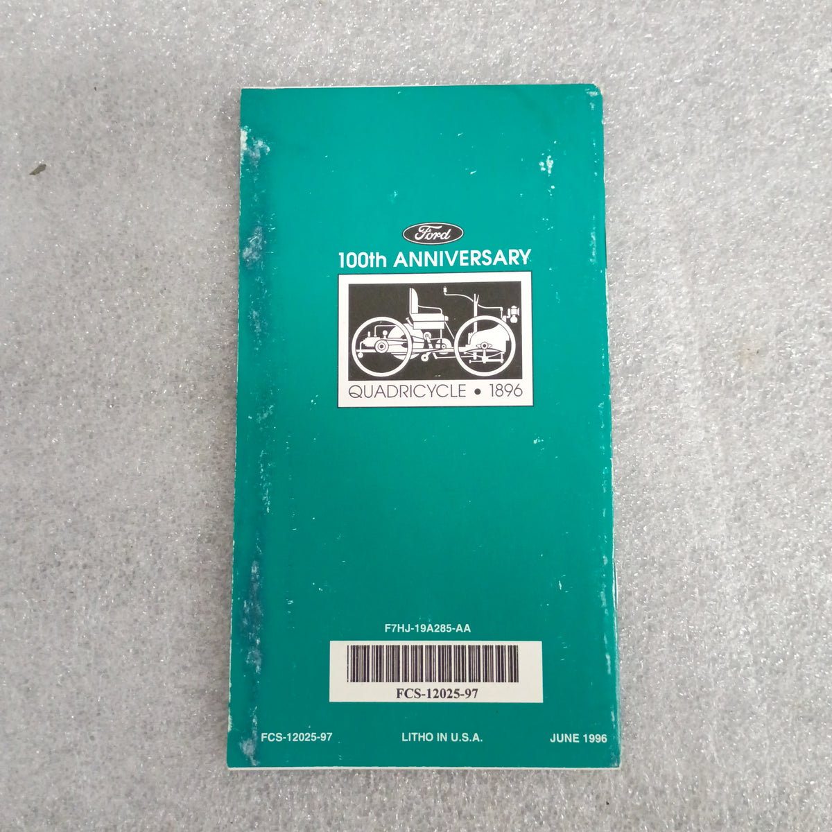 Ford 100th Anniversary booklet for Quadracycle, 1896. Green cover with illustration and barcode, worn condition.
