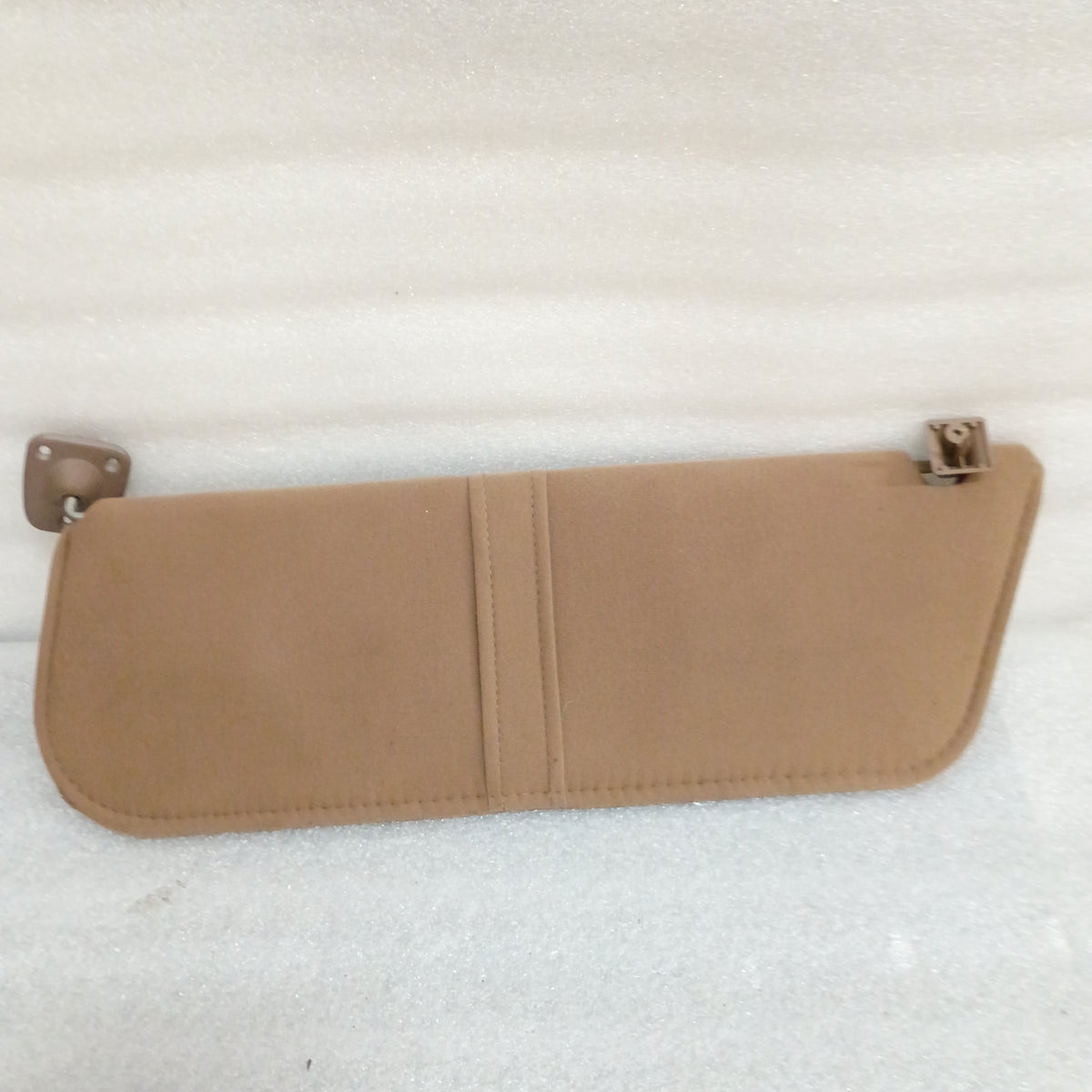 Tan cloth sun visor for Ford trucks and Bronco, with hinges and a paper loop. OEM, minor blemishes visible.