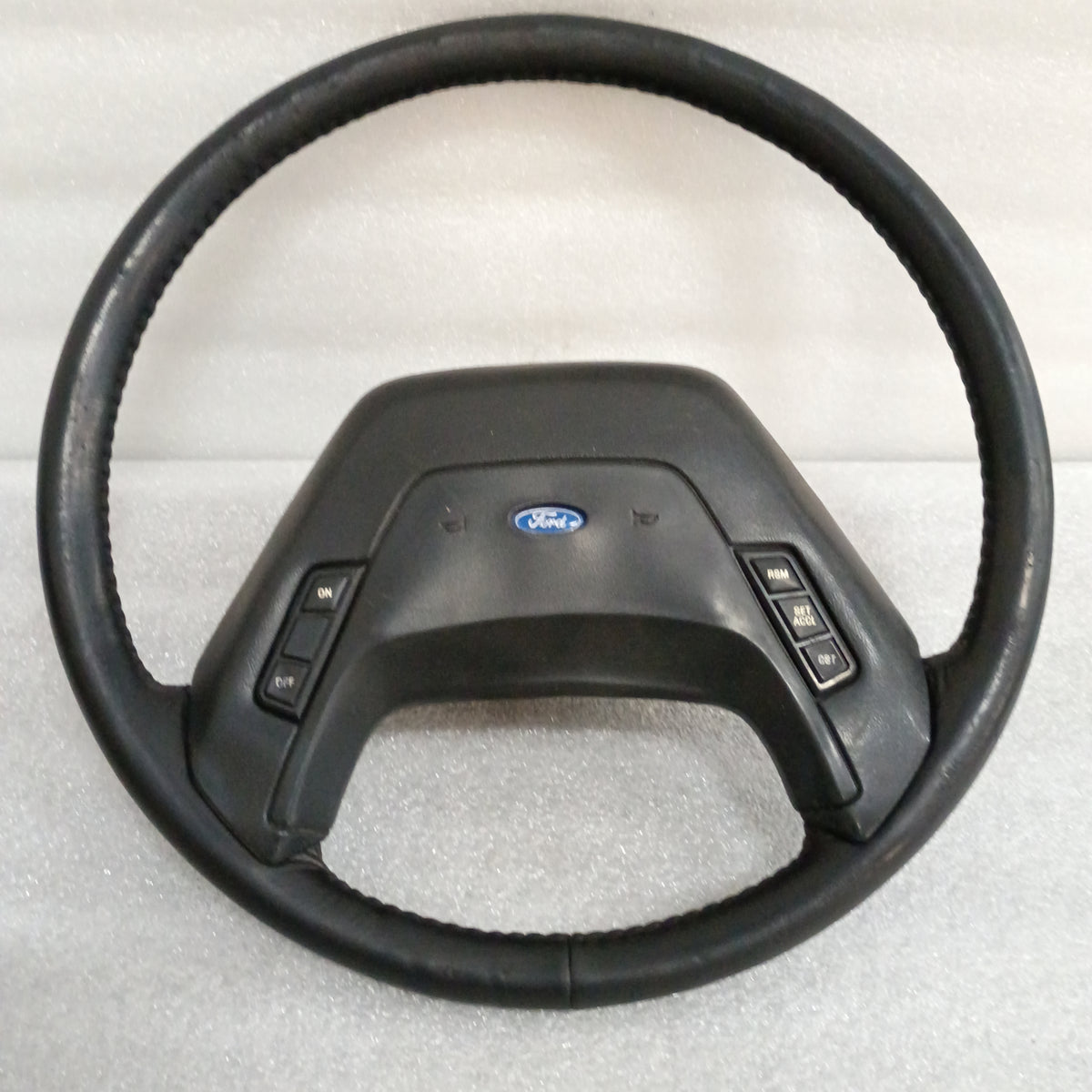 Ford leather steering wheel for 1987-1991 F-Series/Bronco with horn pad, cruise control buttons, excellent condition.