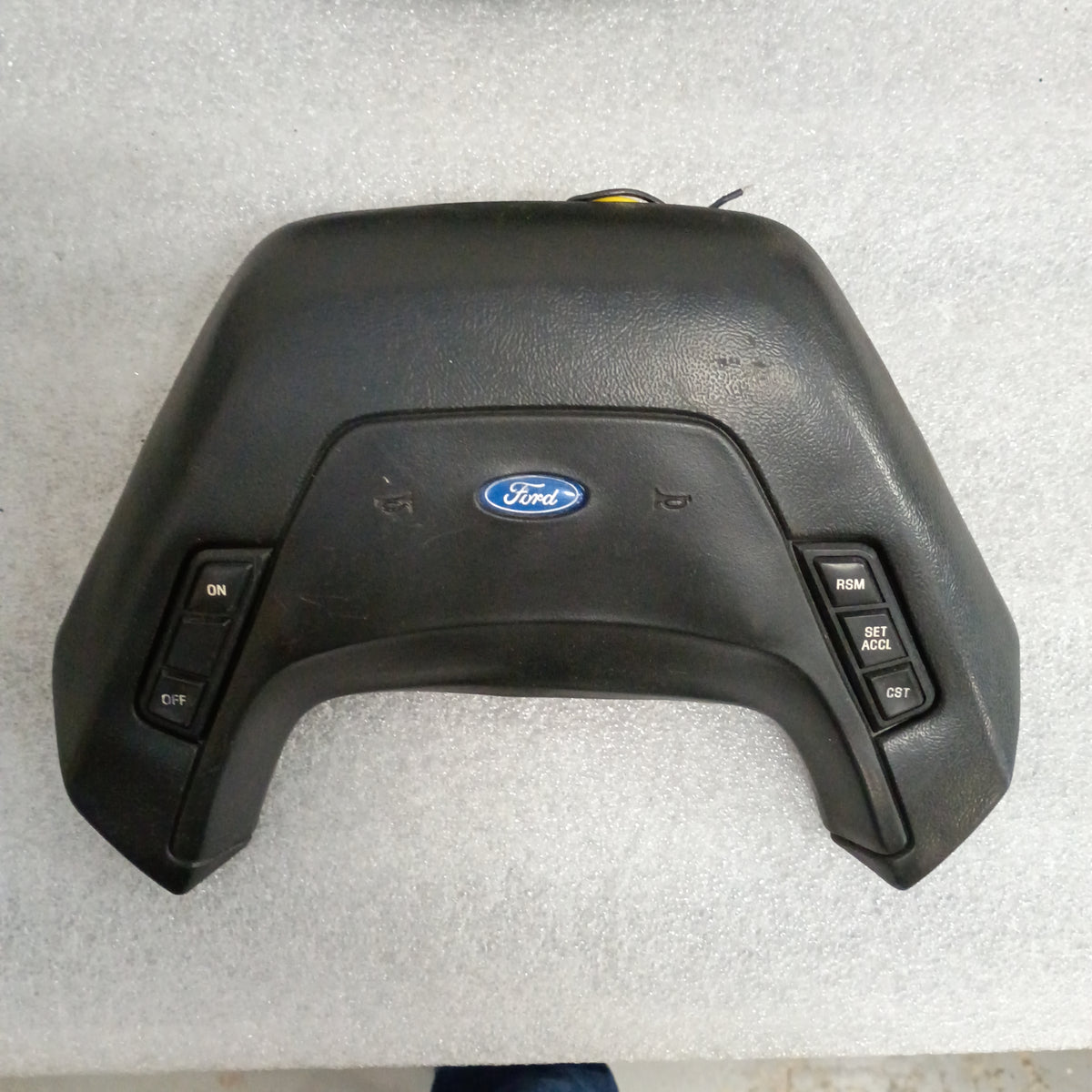 Ford leather steering wheel horn pad with cruise control buttons for 1987-1991 F150, F250, F350, Bronco. OEM, excellent condition.