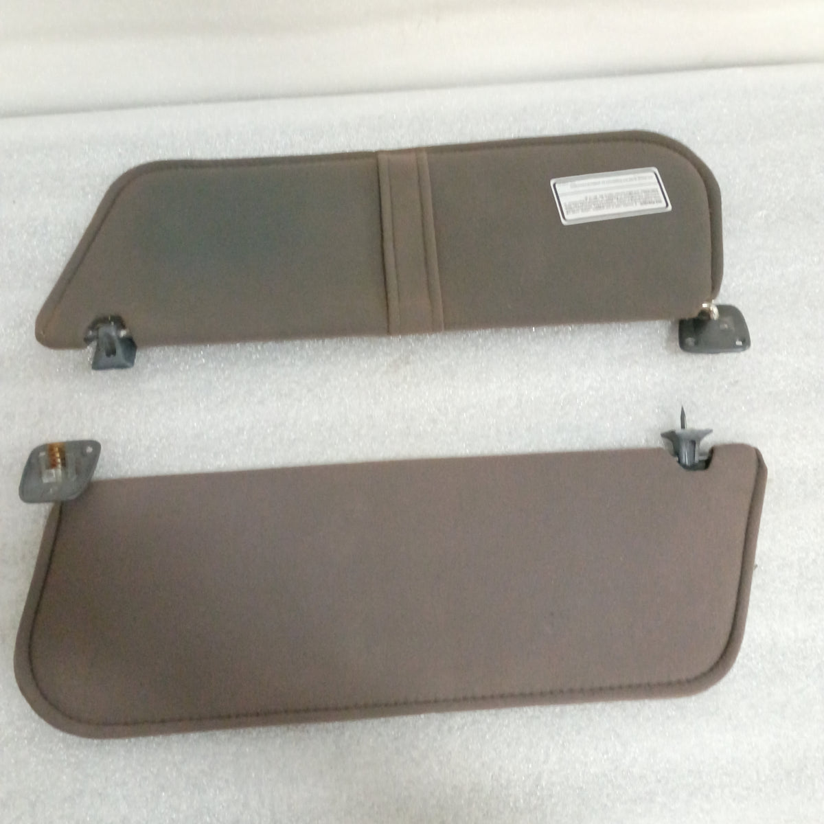 Dark gray cloth sun visors pair for 1987-1991 Ford F-150, F-250, F-350, Bronco; includes vanity mirror and hinges.
