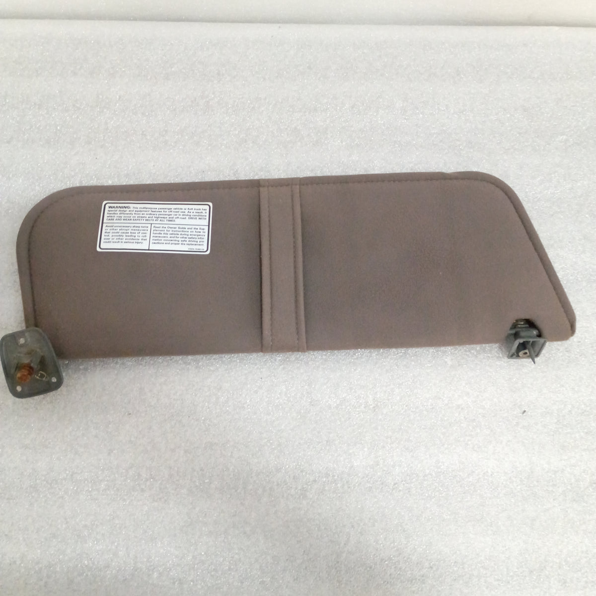 Dark gray cloth sun visor with hinges and warning label, compatible with 1987-1991 Ford Bronco and F-Series trucks.