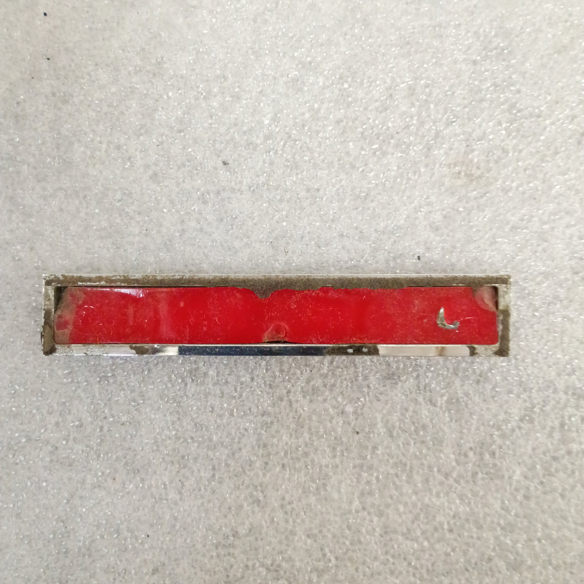 Red and chrome emblem with visible wear, intended for Ford XLT Diesel vehicles, requiring new adhesive for mounting.