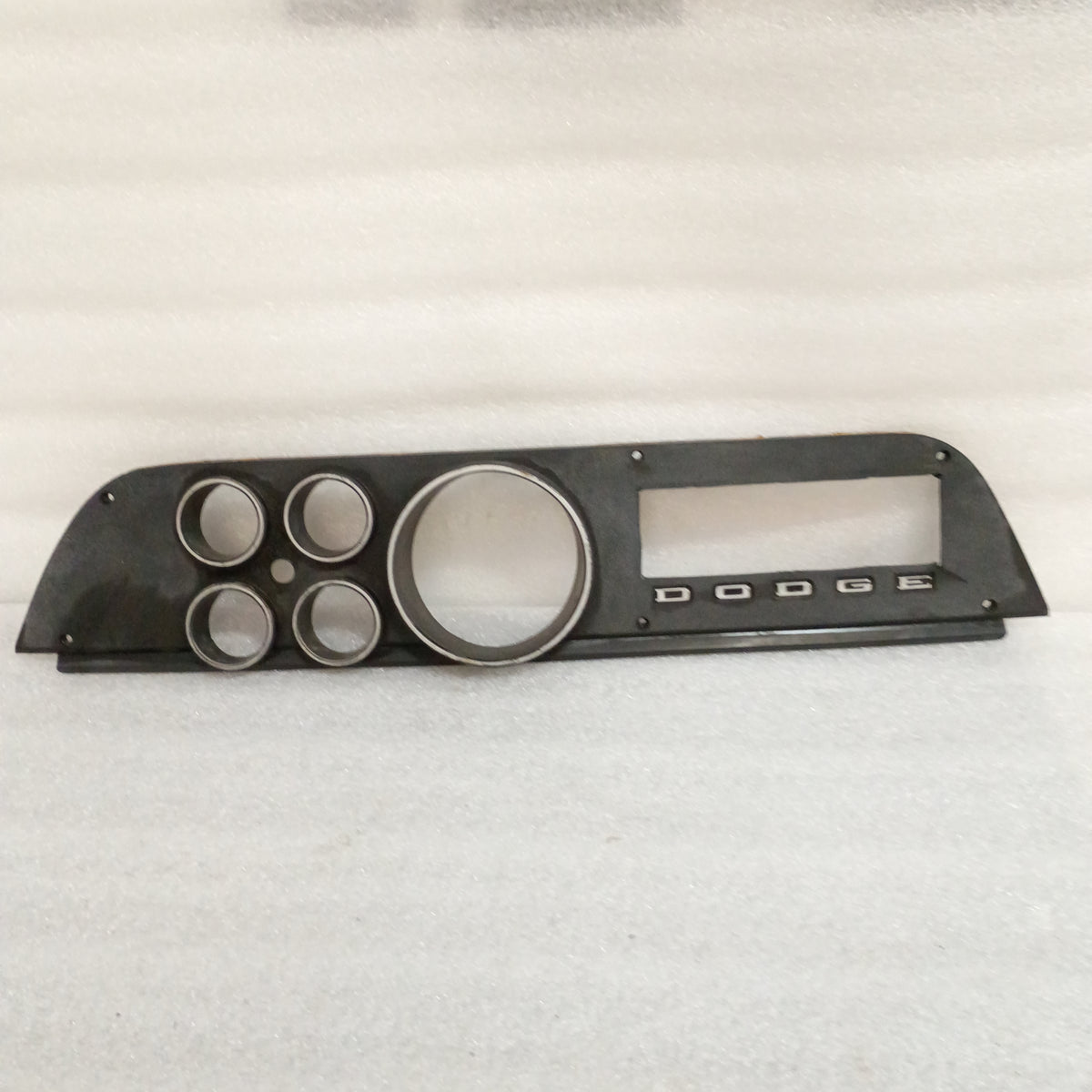 Black OEM Dodge gauge cluster bezel for 1972-1974 D100/D200/D300/W100/Ramcharger, with round gauge openings and Dodge logo.
