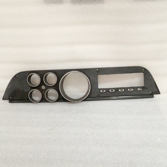 Black OEM Dodge gauge cluster bezel for 1972-1974 D100/D200/D300/W100/Ramcharger, with round gauge openings and Dodge logo.
