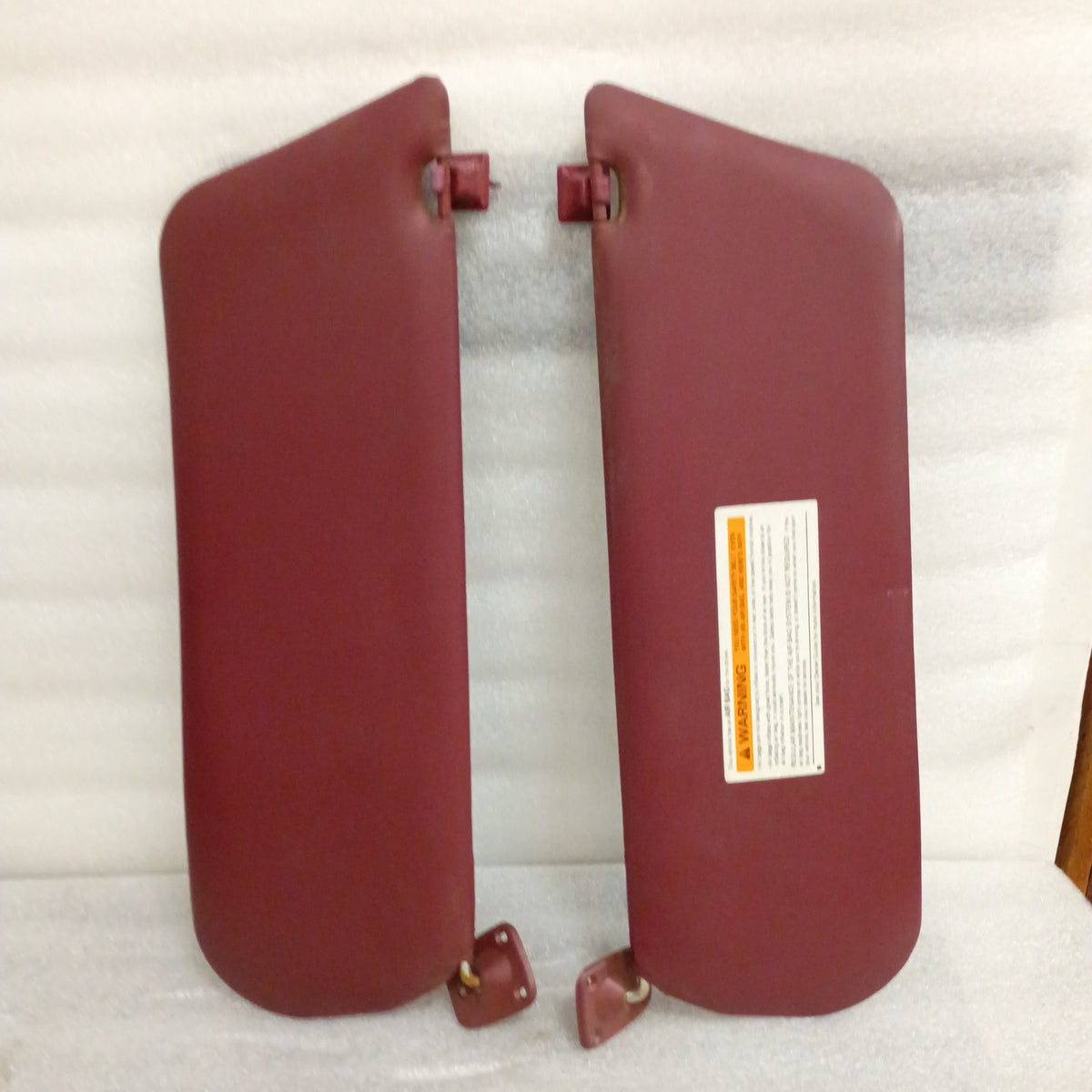Dark red vinyl sun visors pair with hinges, compatible with 1992-1997 Ford Bronco, F150, F250, F350. OEM Ford parts.