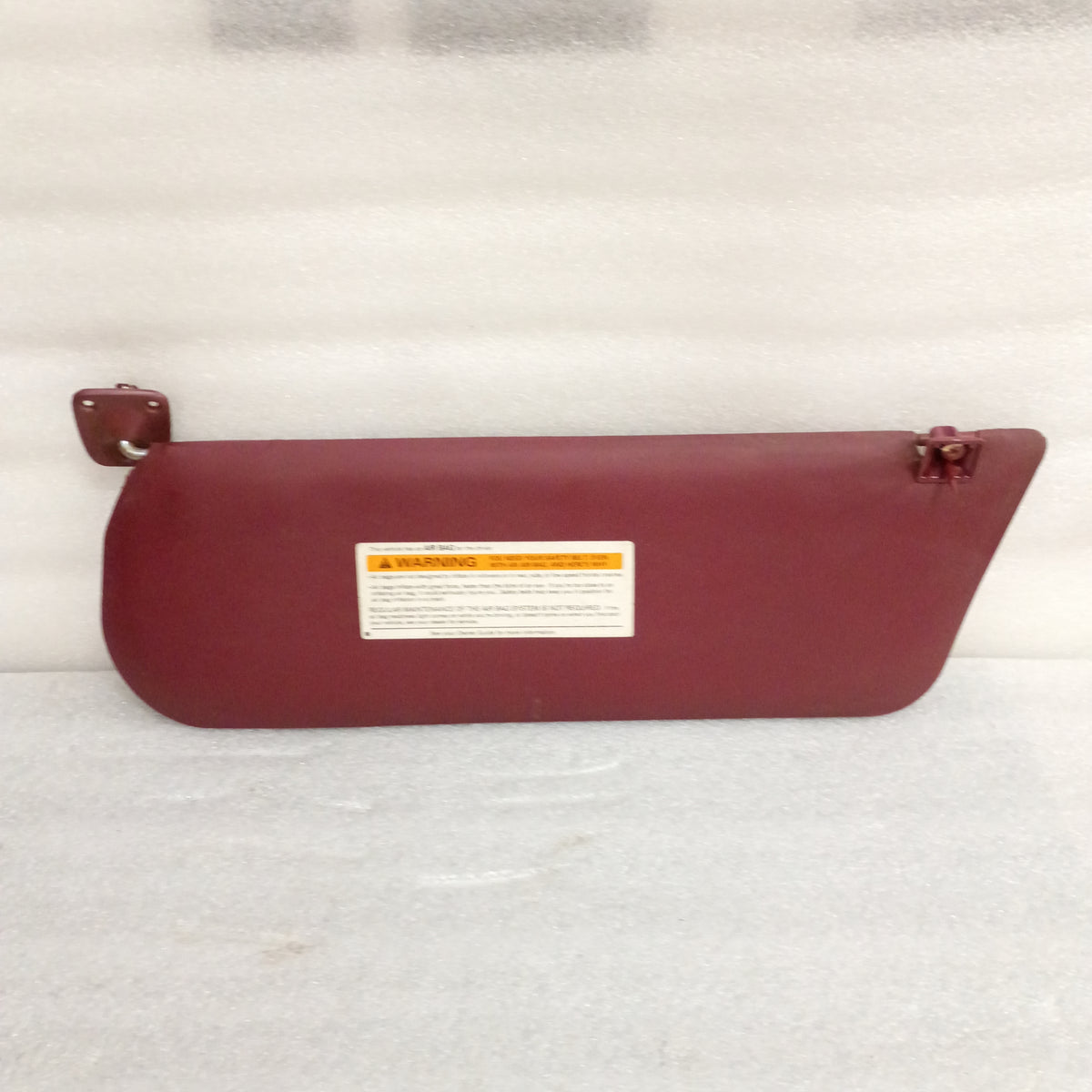 Dark red vinyl sun visor for 1992-1997 Ford vehicles, includes hinges and swivels, OEM Ford part E0TB-1004122-AWD.