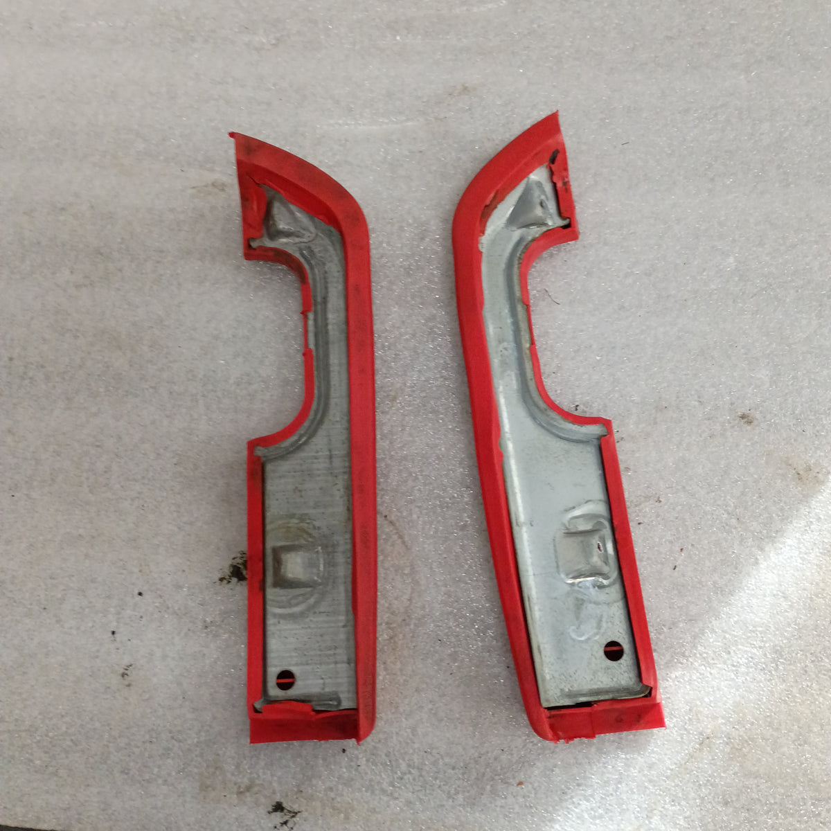 Red arm rest set for 1973-1979 Ford F100-F350, Bronco. OEM parts with plastic door pull cups shown on a white surface.
