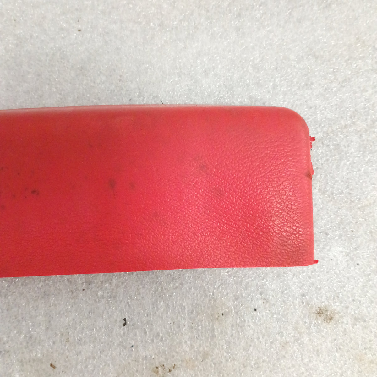 Red armrest for 1973-79 Ford F100-F350, Bronco; OEM Ford part, textured surface, includes door pull cups.