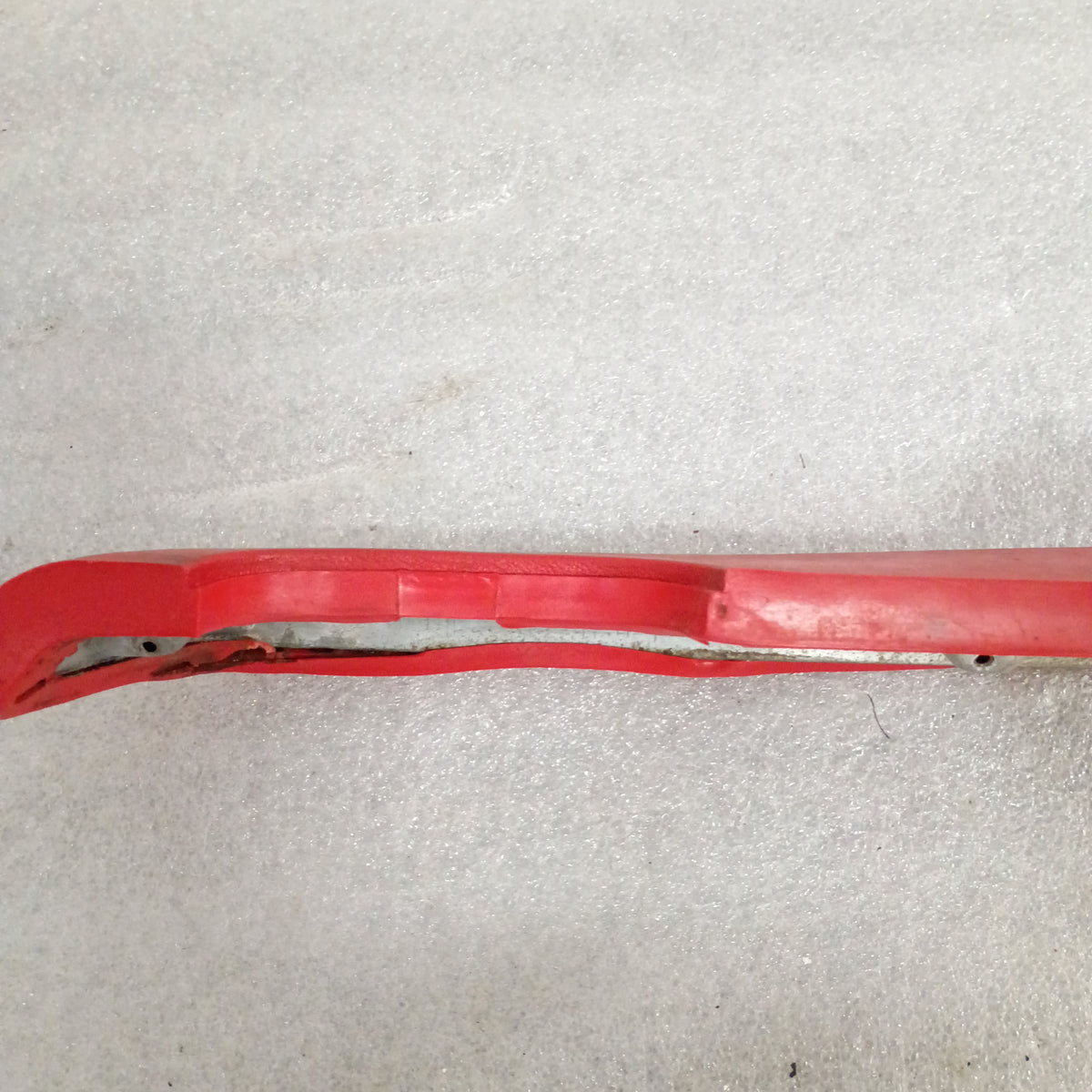 Red armrest for 1973-1979 Ford F-series trucks and Bronco, includes OEM plastic door pull cups, side view.