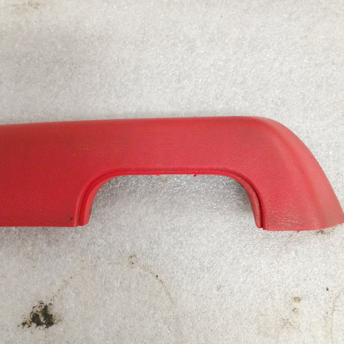 Red armrest for 1973-1979 Ford F100-F350 and Bronco, showing OEM design with a plastic cup for door pull.