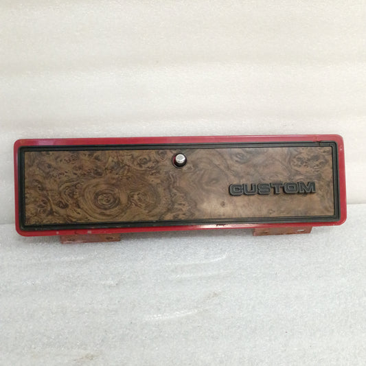 Red glove box door with wood grain finish and "CUSTOM" emblem, compatible with 1973-1979 Ford F100-F350, includes push button latch.