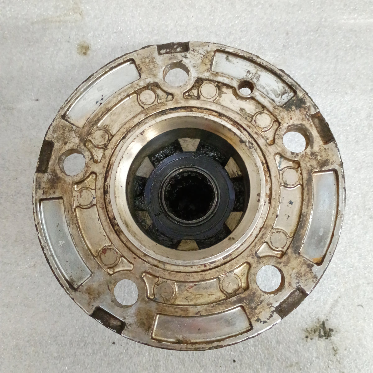 Top view of a used OEM Ford Top Hat Manual Locking Hub for 1987-1988 F-150 and Bronco, showing bolt holes and splines.