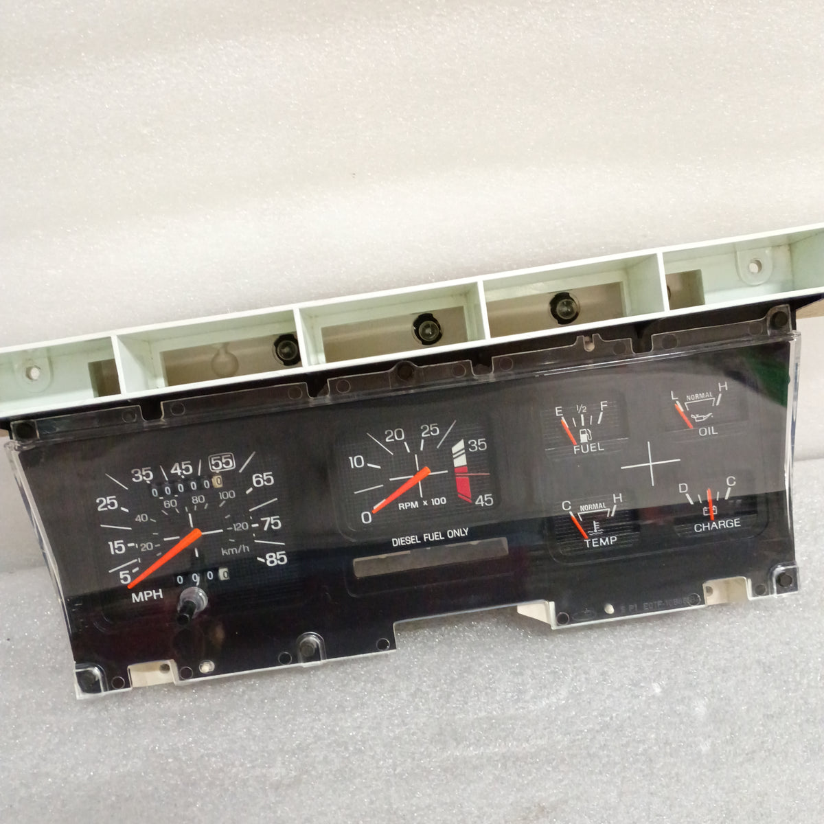 Refurbished diesel gauge cluster with tachometer for 1980-1986 Ford trucks and Broncos, featuring a new lens and operable gauges.