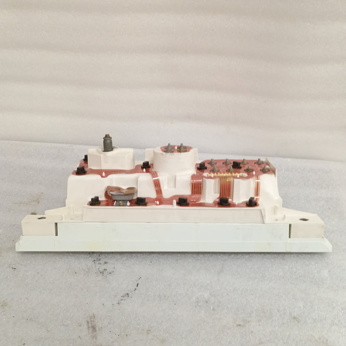 Refurbished Ford 80-86 truck diesel gauge cluster back view, showing copper circuit traces, connectors, and housing components.