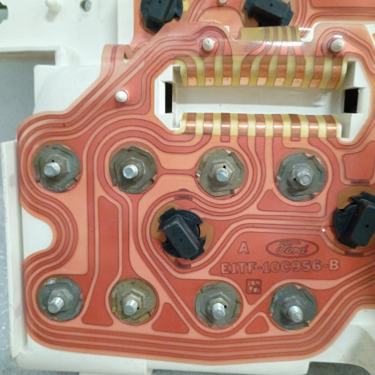 Close-up of a Ford truck gauge cluster circuit board, showing connections and electronic components on a refurbished unit.