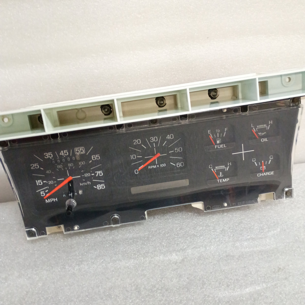Refurbished Ford F-series and Bronco gauge cluster with tachometer, speedometer, and fuel, oil, temp, charge gauges.