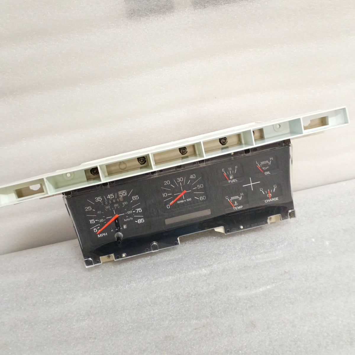 Refurbished 80-86 Ford truck gauge cluster with tachometer, speedometer, fuel, temp, oil, and alternator gauges.
