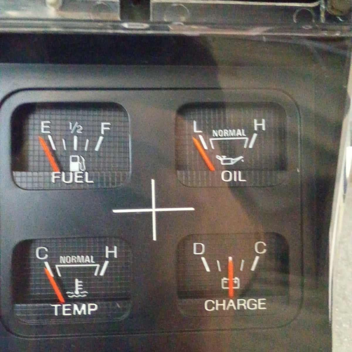 Ford truck gauge cluster showing fuel, oil, temperature, and charge indicators. Refurbished with Dennis Carpenter lens.