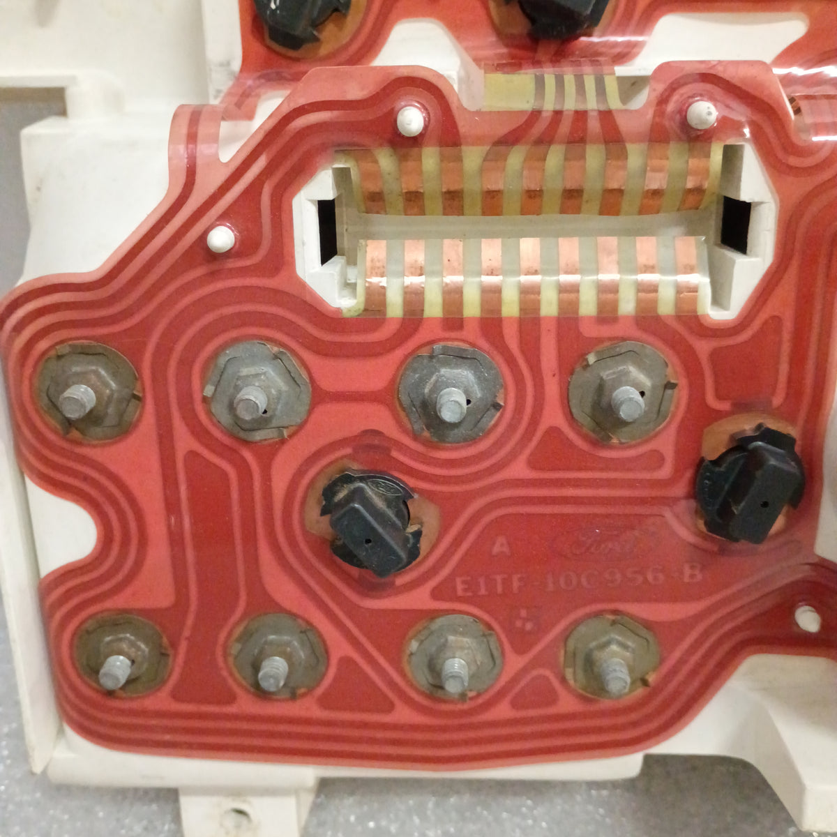 Refurbished Ford truck gauge cluster back view with red circuit board and multiple connectors for 1980-1986 F150, F250, F350, Bronco.
