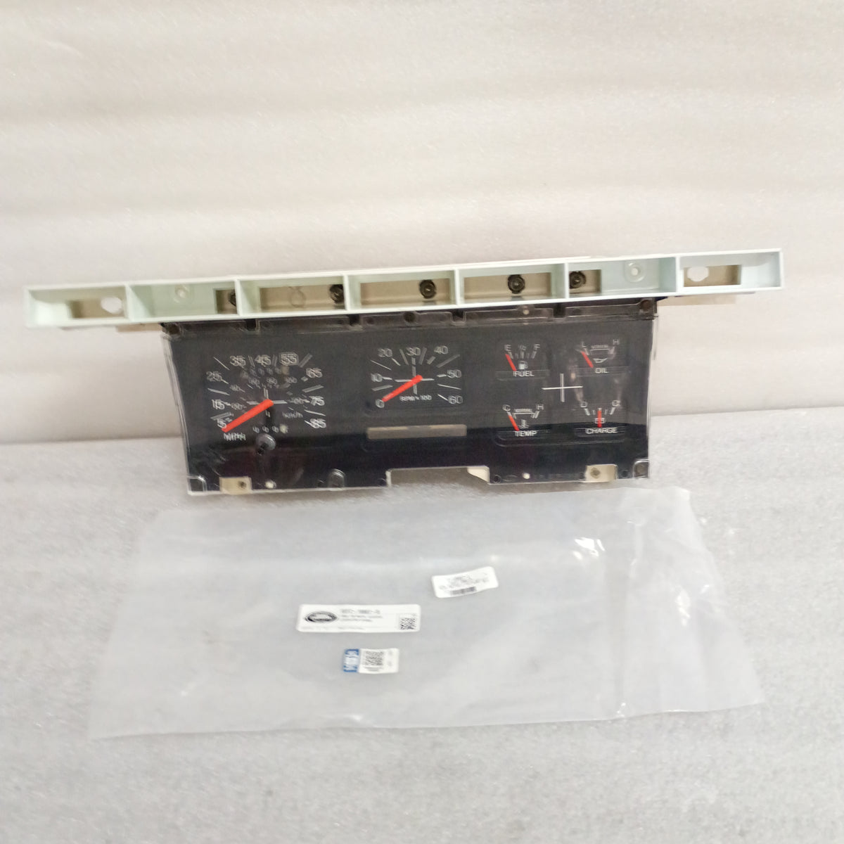 Refurbished Ford 80-86 truck gauge cluster with tachometer, odometer reset, and new Dennis Carpenter lens, suitable for F150-F350 and Bronco.