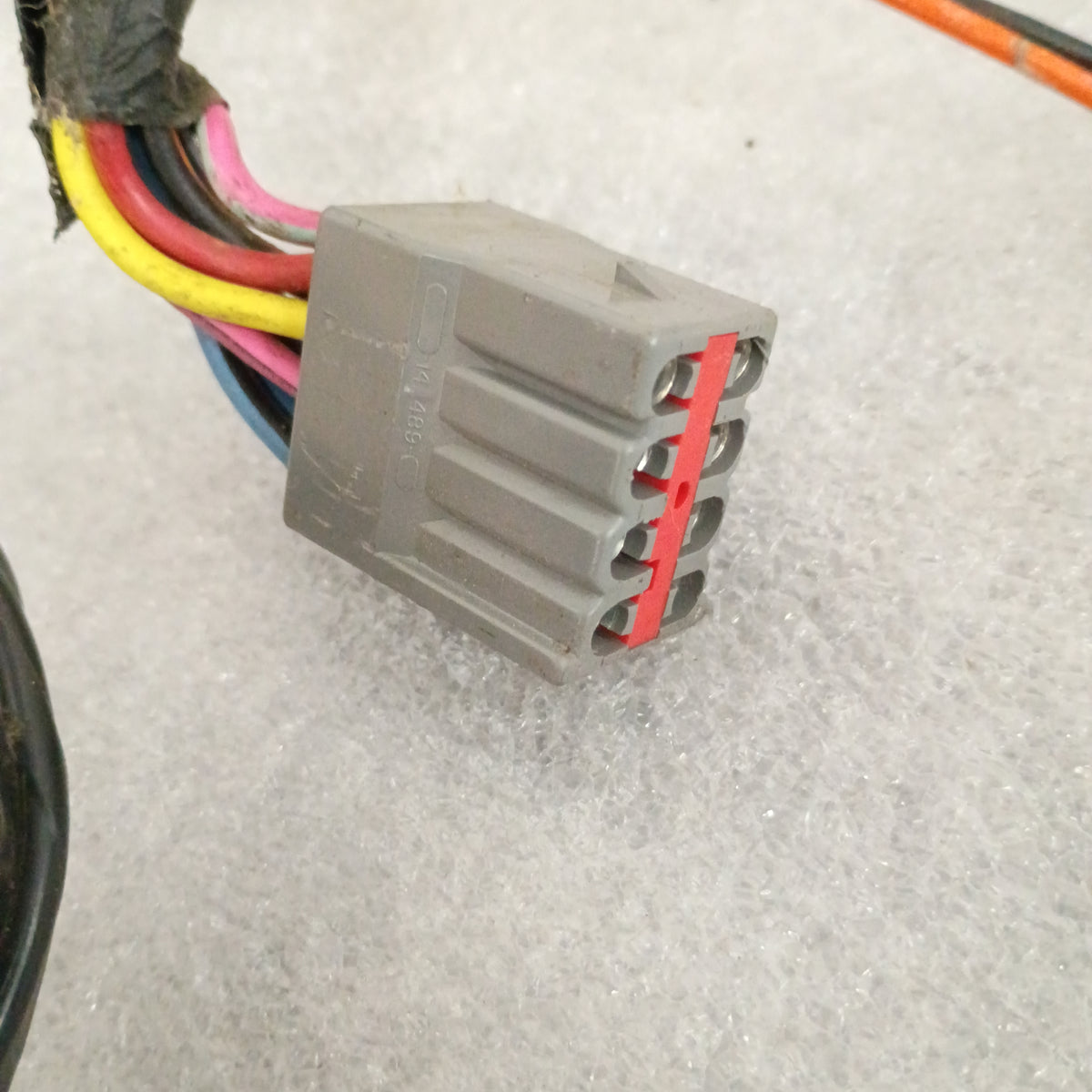 Close-up of a gray wiring connector with multicolored wires for Ford power window and lock door harness, suitable for 1987-1991 F-Series and Bronco.
