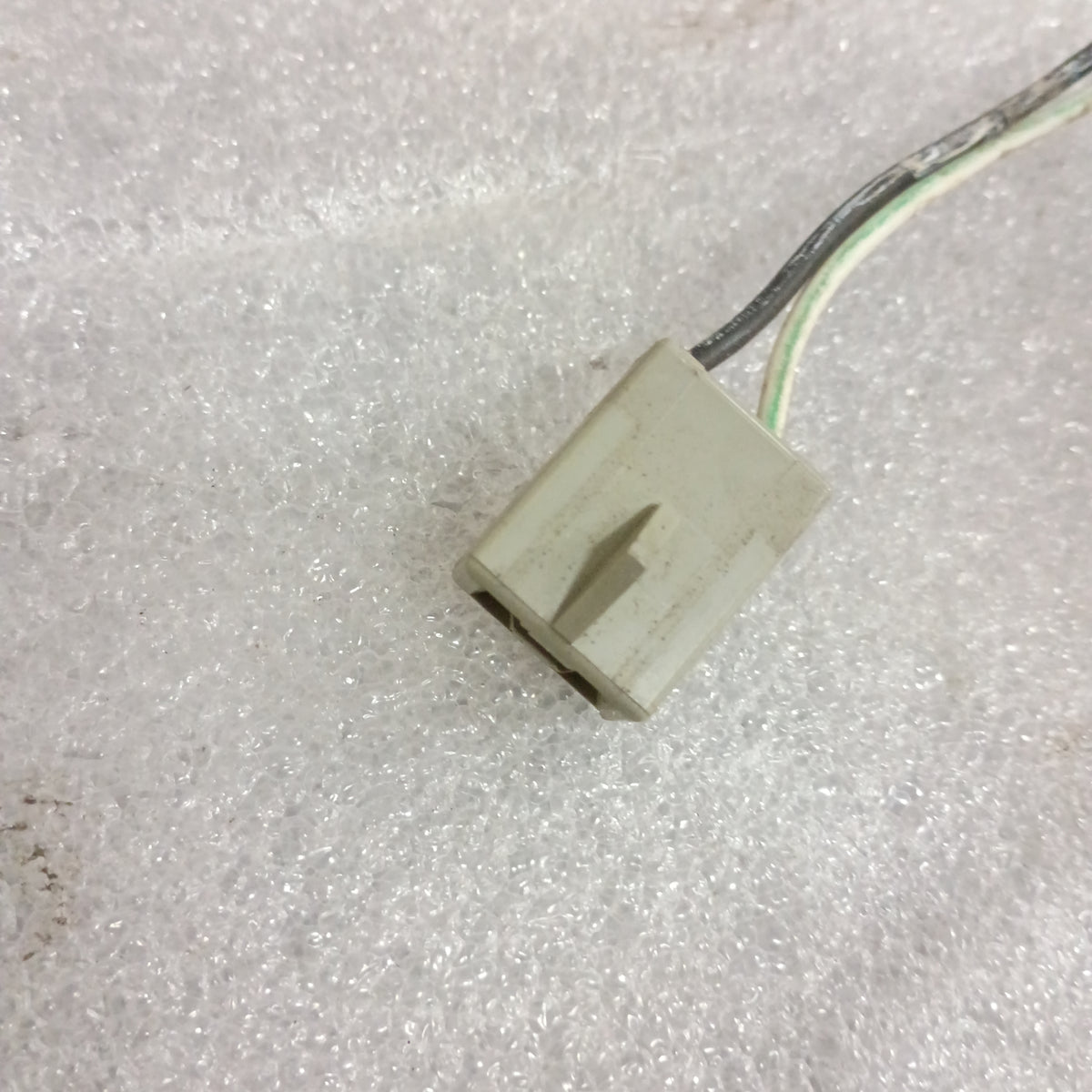 Close-up of a Ford power window and door lock wire harness connector for 1987-1991 F-150, F-250, F-350, and Bronco.