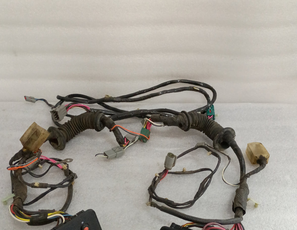 Ford wire harness for 1987-1991 Bronco and F-Series, featuring connectors and rubber boots for power windows and locks.
