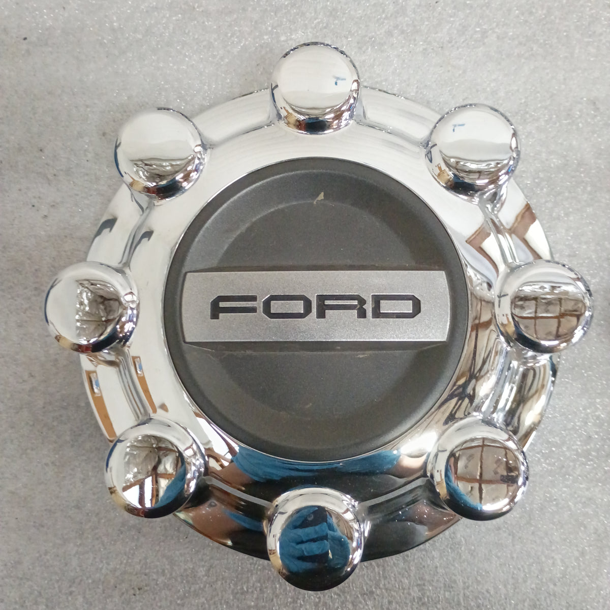 Chrome Ford wheel center cap, featuring the Ford logo, for 2017-2023 F-250/F-350, 8.375" diameter, genuine OEM part.
