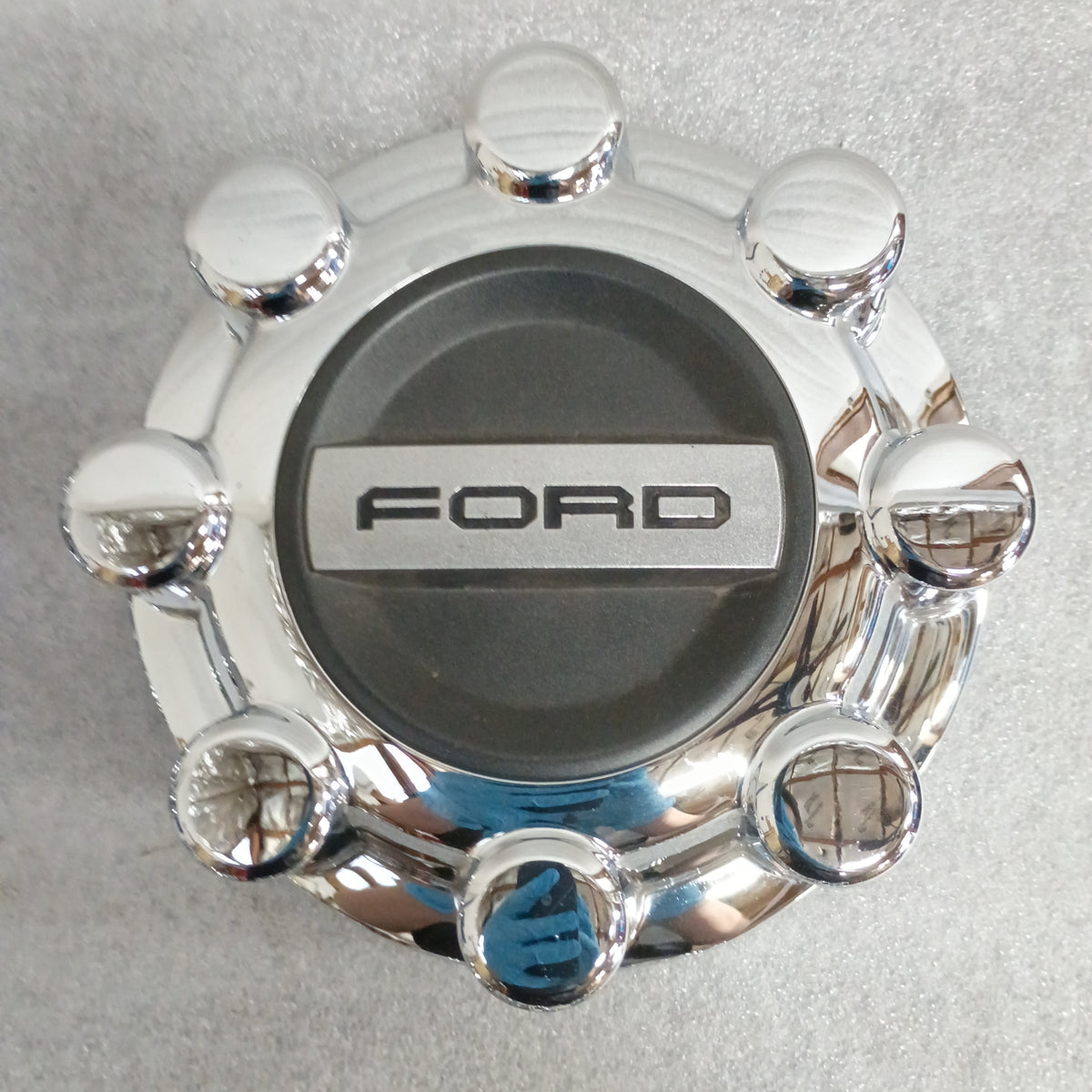 Chrome Ford wheel center cap, featuring a raised logo, compatible with 2017-2023 F-250 and F-350 Super Duty models.