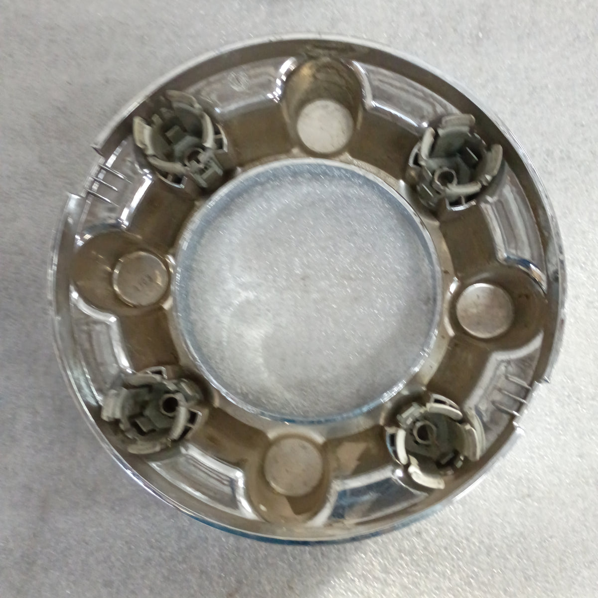 Chrome wheel center cap with plastic clips, part of genuine OEM set for 2017-2023 Ford F-250/F-350 Super Duty.