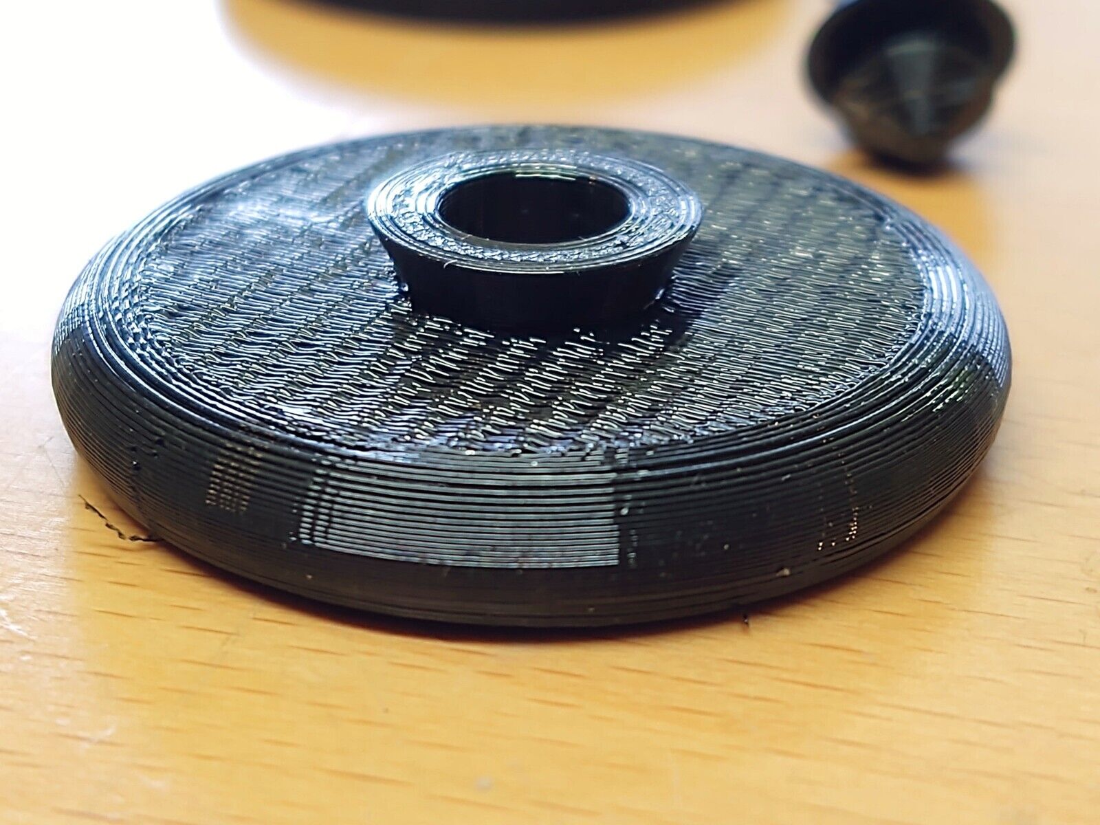 Black circular rubber foot pad with a textured, ribbed top and raised center collar, designed as a replacement part for 1980-1991 Ford F150, F250, F350, and Bronco center consoles.